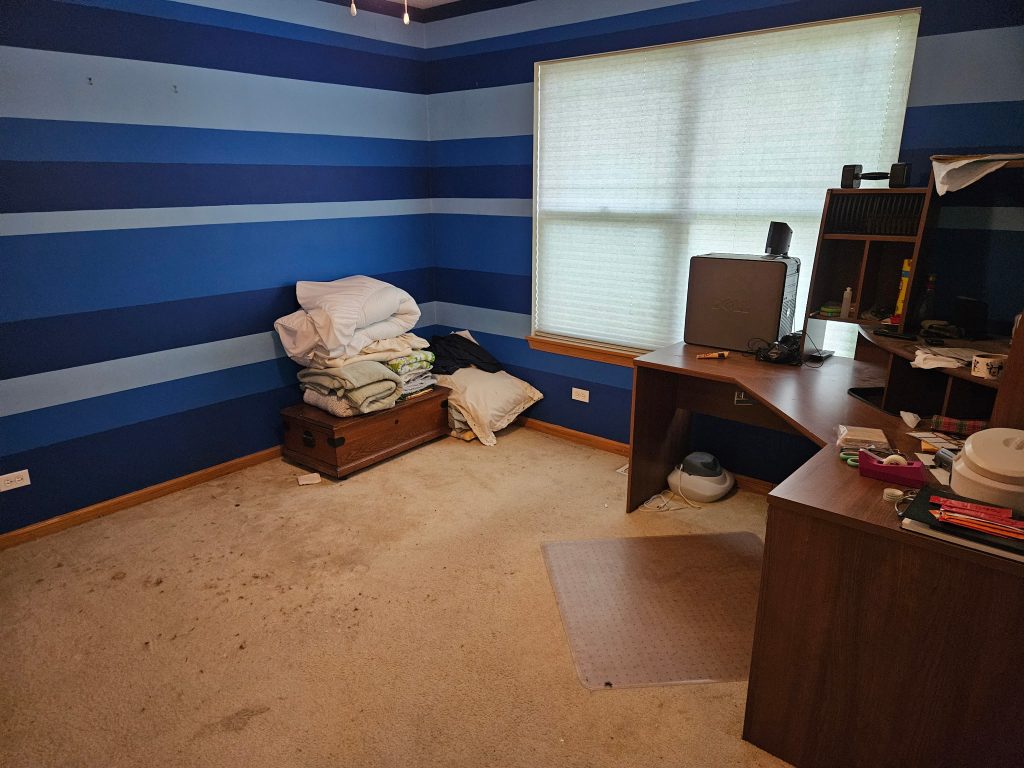 Bedroom with desk and mixed items before junk removal cleanout by Junk Nurse in Aurora IL