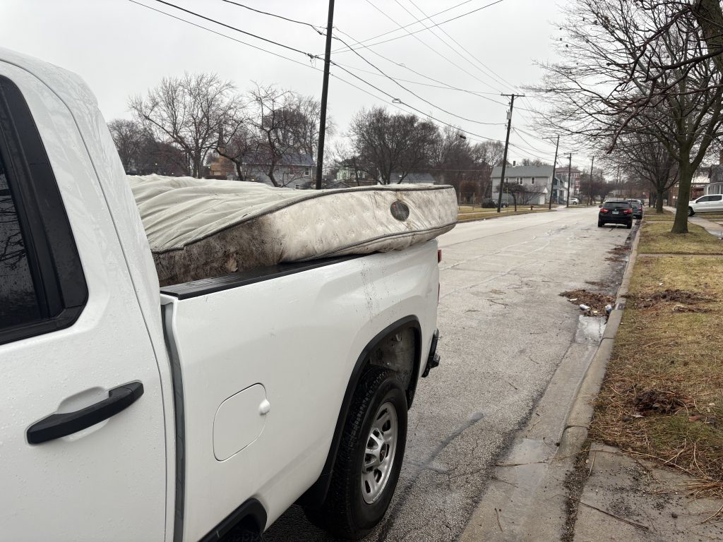 Old mattress loaded in Junk Nurse pickup truck for removal in Aurora IL