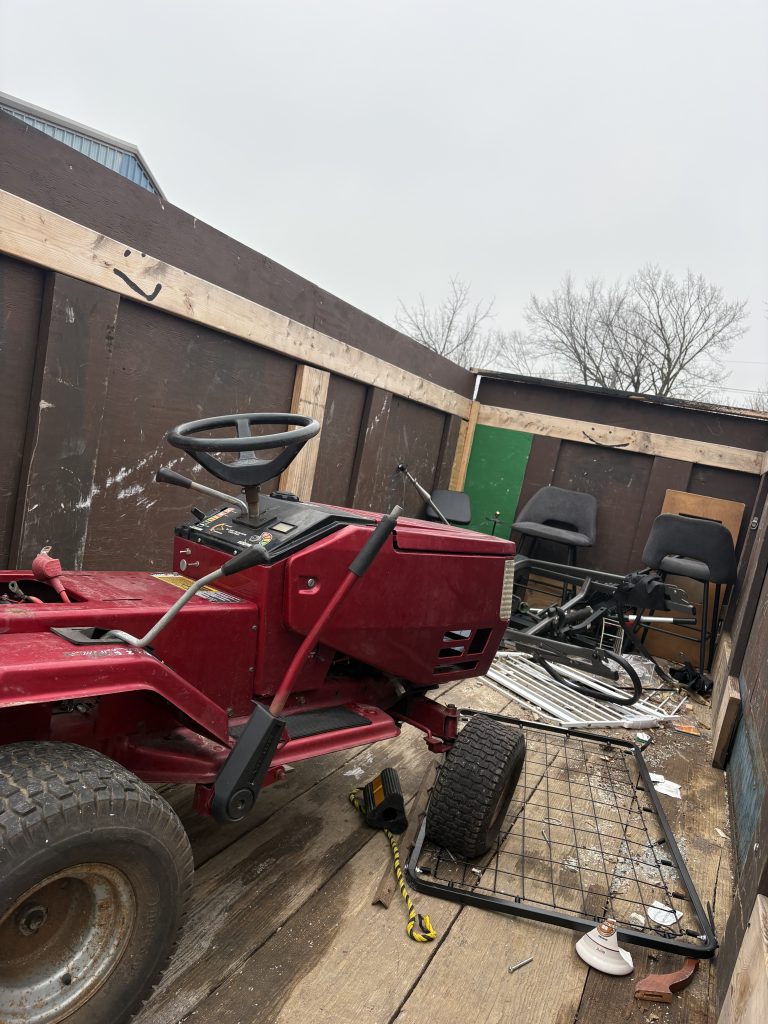 Old red riding lawn mower hauled away by Junk Nurse junk removal in Aurora IL