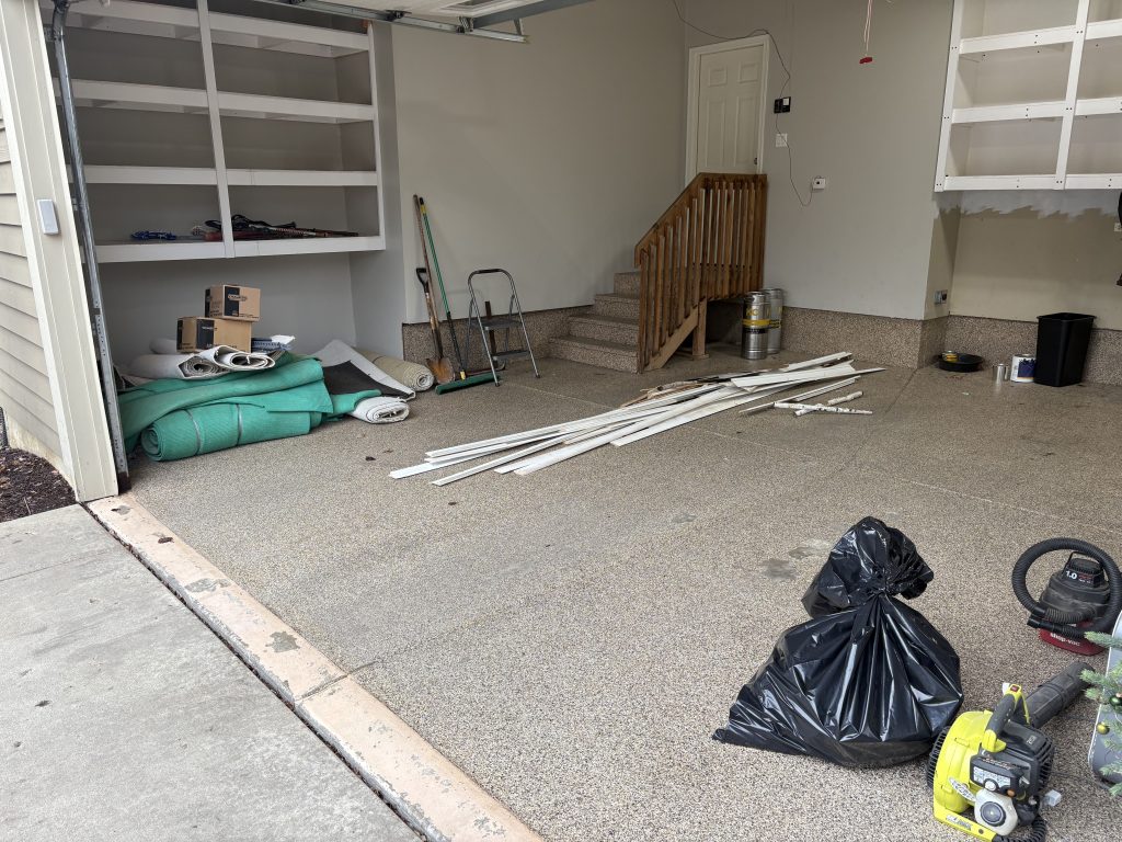Garage packed with trash bags and mixed junk before Junk Nurse cleanout in Aurora IL