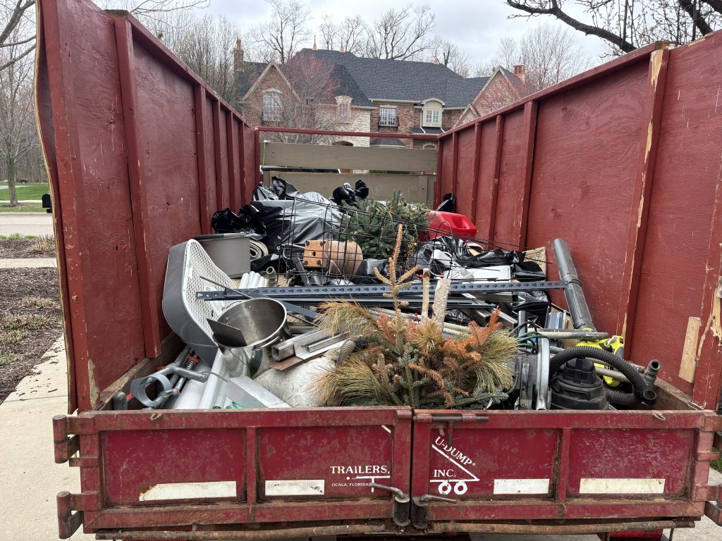 Dump trailer fully loaded with mixed junk and debris after a Junk Nurse removal job in Aurora IL
