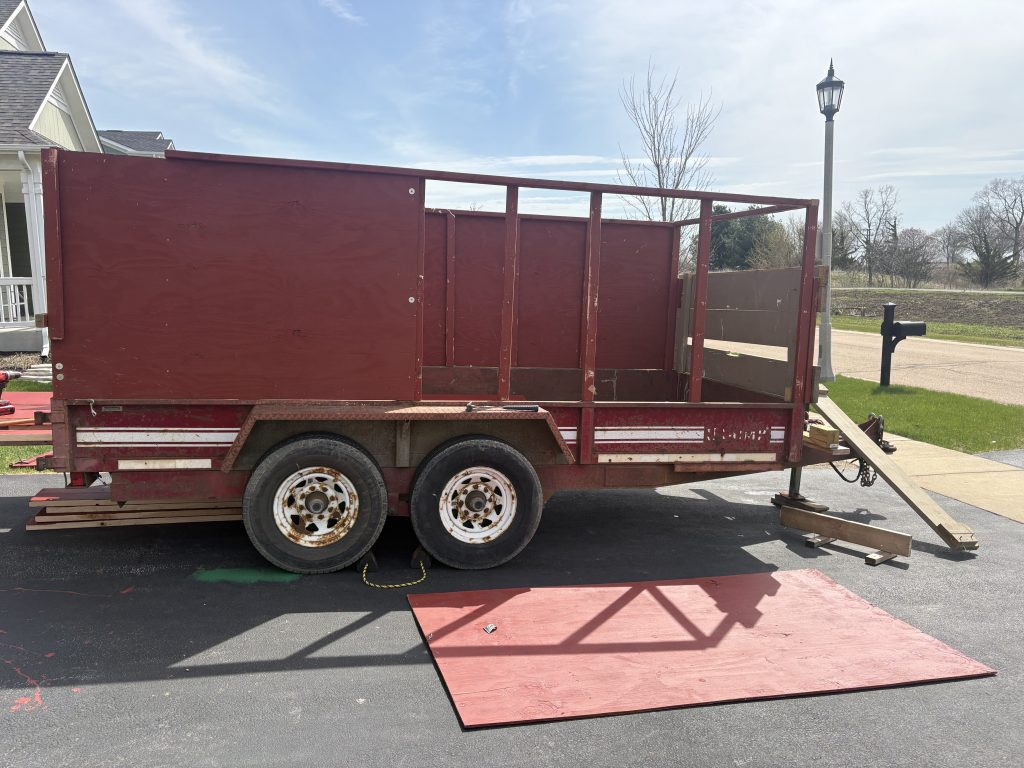 Junk Nurse maroon dump trailer parked in a residential neighborhood in the Geneva IL area