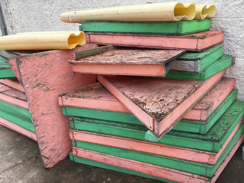 Stacked painted demolition debris and insulation boards staged for removal by Junk Nurse in Aurora IL