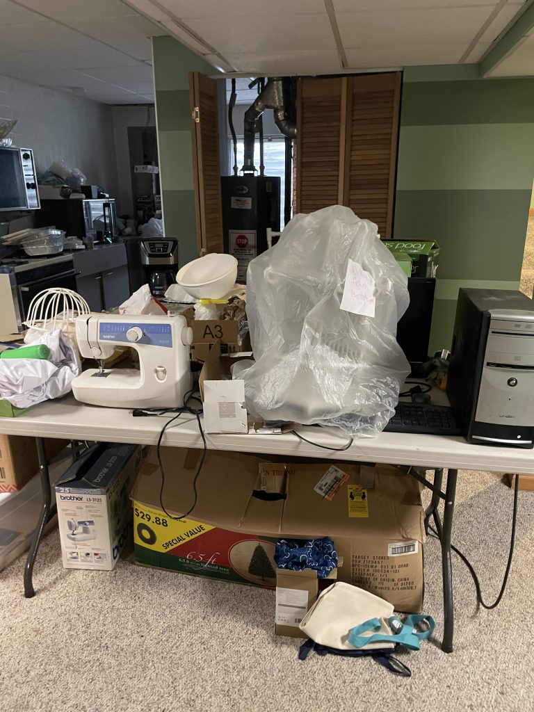 Cluttered room with overloaded wire shelving unit full of boxes during estate cleanout in Aurora IL