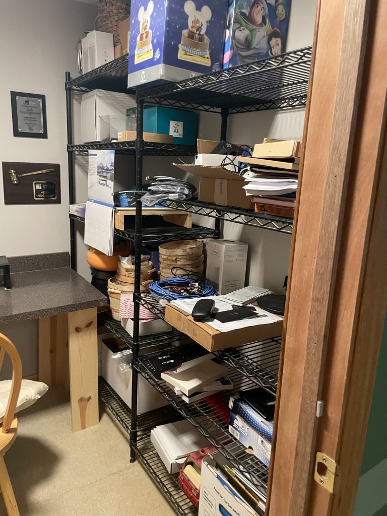 Home office shelving unit packed with papers, boxes and items before estate cleanout by Junk Nurse Aurora IL