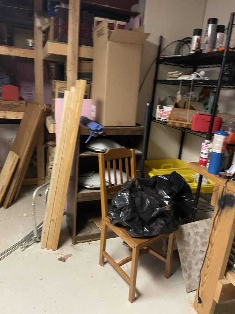 Fully packed basement with chairs, lumber and assorted junk before Junk Nurse cleanout in Aurora IL