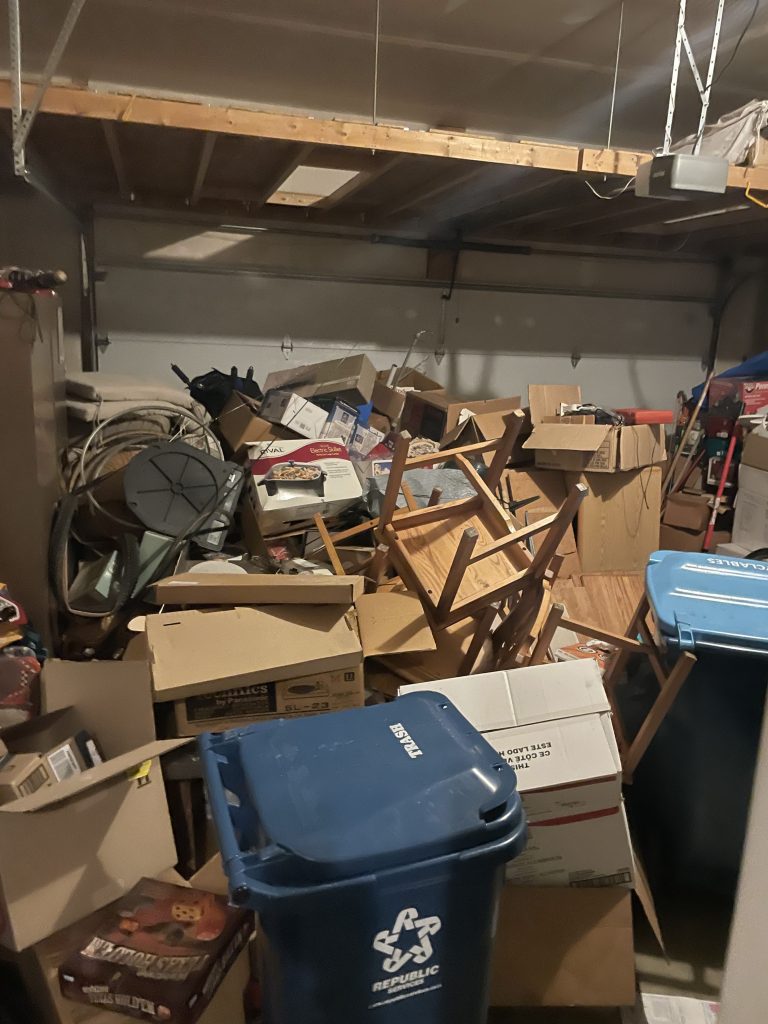 Basement overflowing with boxes, furniture and junk before full cleanout by Junk Nurse in Aurora IL