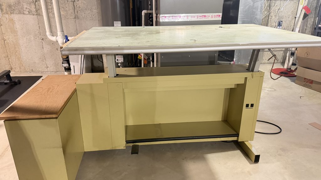 Old green metal office desk removed from commercial property by Junk Nurse junk removal in Aurora IL