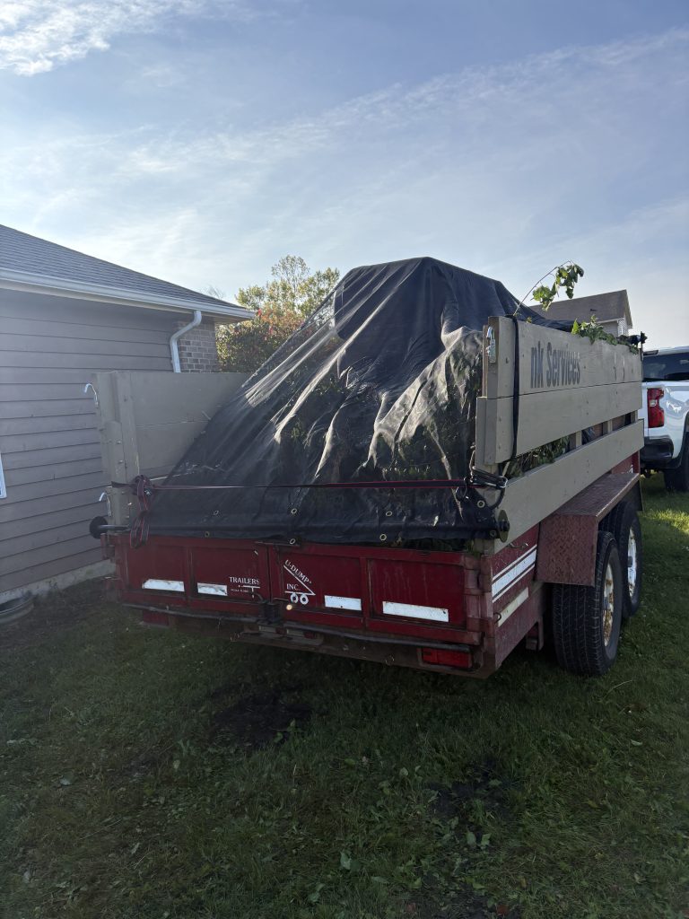 Junk Nurse red dump trailer loaded and covered with tarp ready for disposal run near Sugar Grove IL