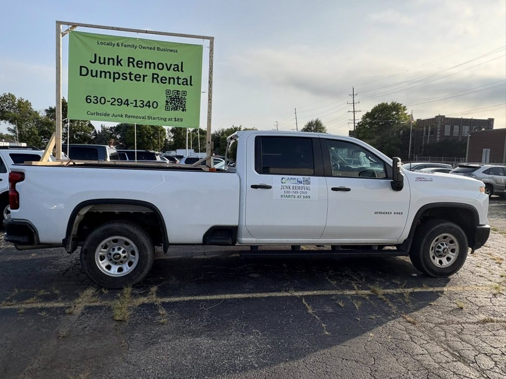 Junk Nurse branded white Chevrolet truck with full door signage in Aurora IL at 630-294-1340