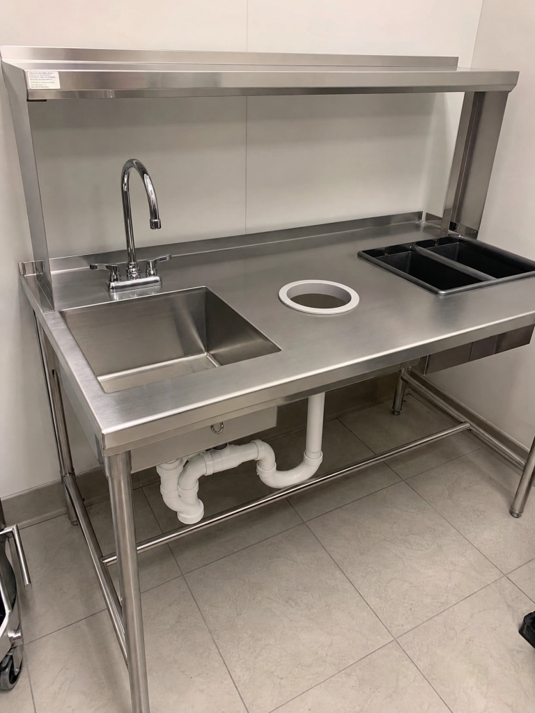 Stainless commercial prep table with integrated sink removed from a restaurant kitchen by Junk Nurse in the Fox Valley IL area