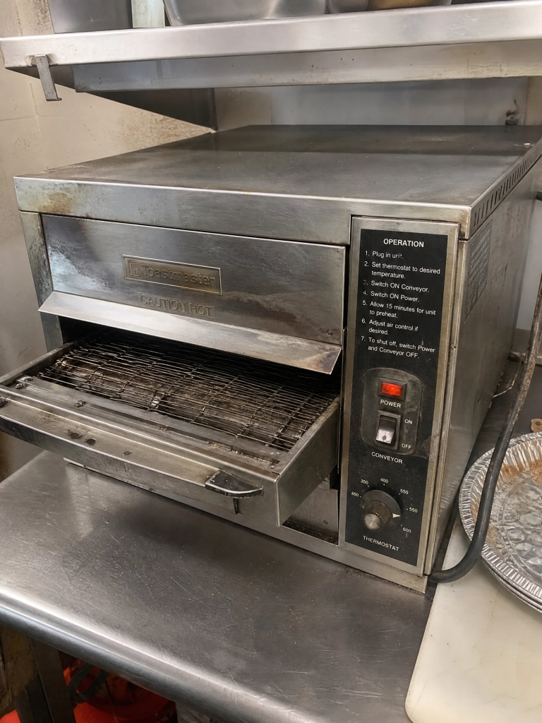Commercial countertop conveyor oven removed from a restaurant during a kitchen equipment cleanout by Junk Nurse in Aurora IL
